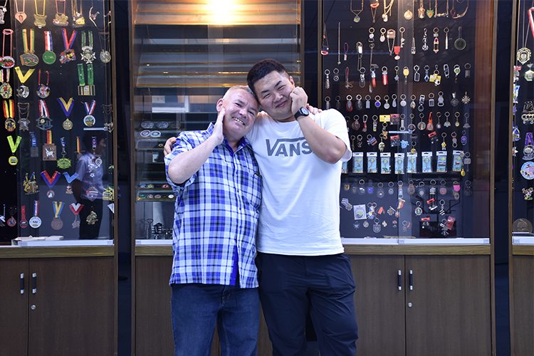 Customer photo in front of custom metal gift display cases