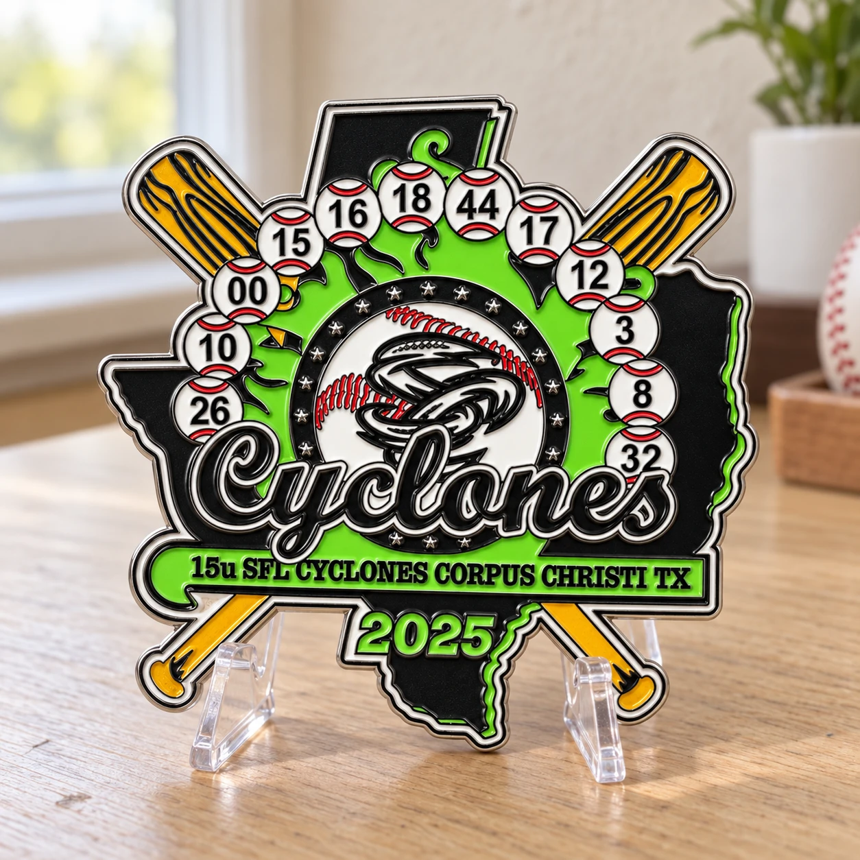 Finished Cyclones team trading pin after revisions, displayed on a clear stand