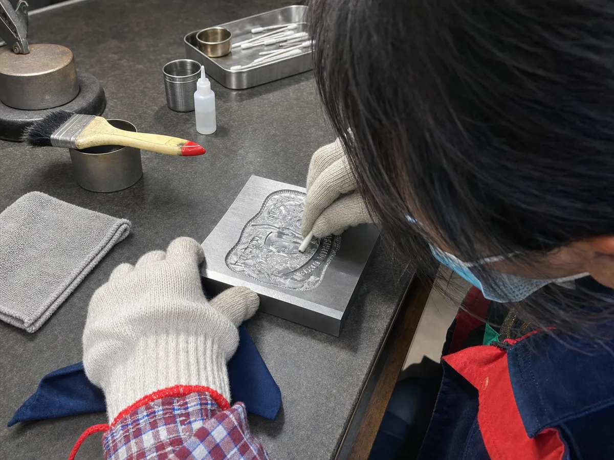 challenge coin mold detail being checked before mass production