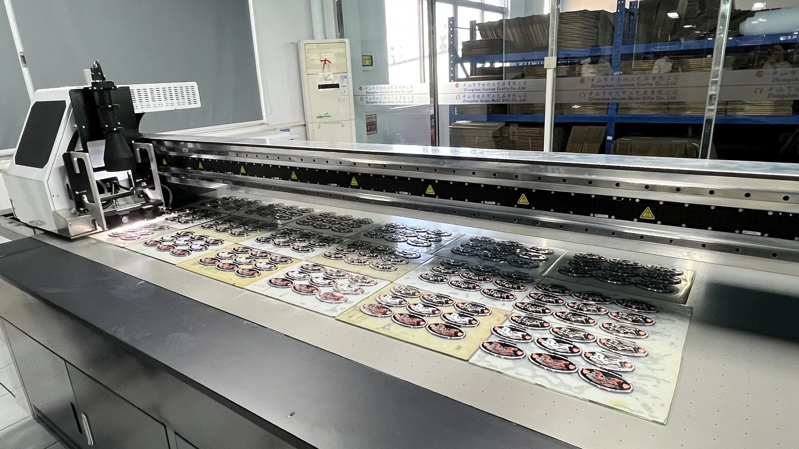 real Unique Pin factory production batch arranged on trays during machine printing