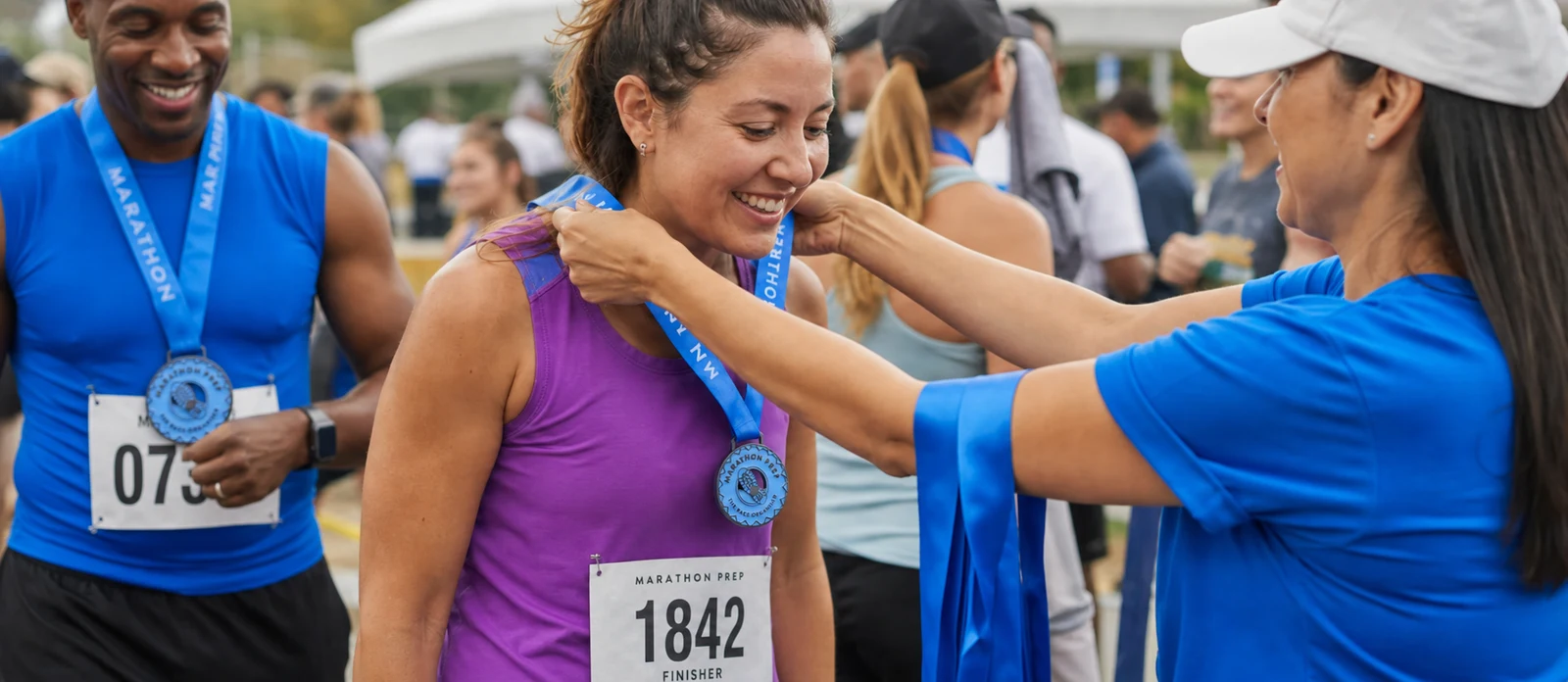 runner wearing race bib 1842 receiving a custom marathon medal