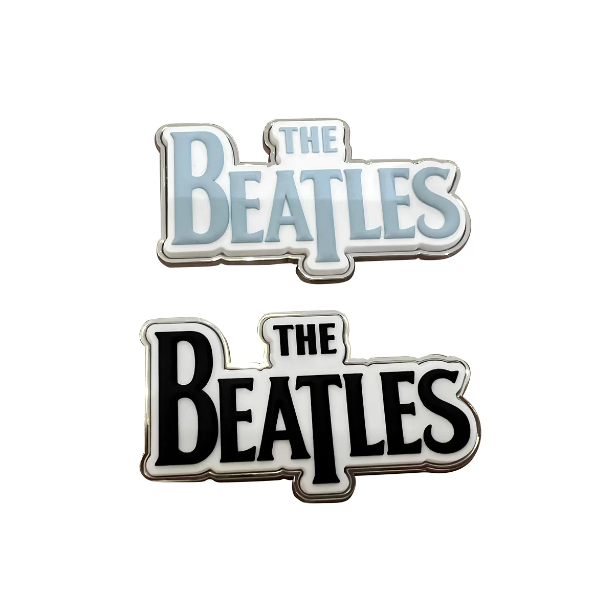 Two Beatles logo metal fridge magnets in pale blue and black color variations