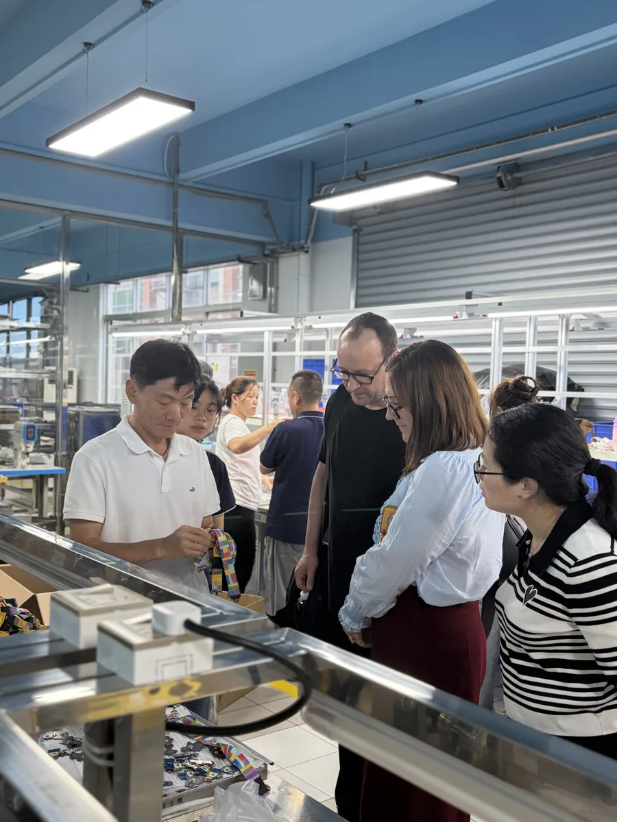 Customers visiting the Unique Pin factory and reviewing custom products with our team
