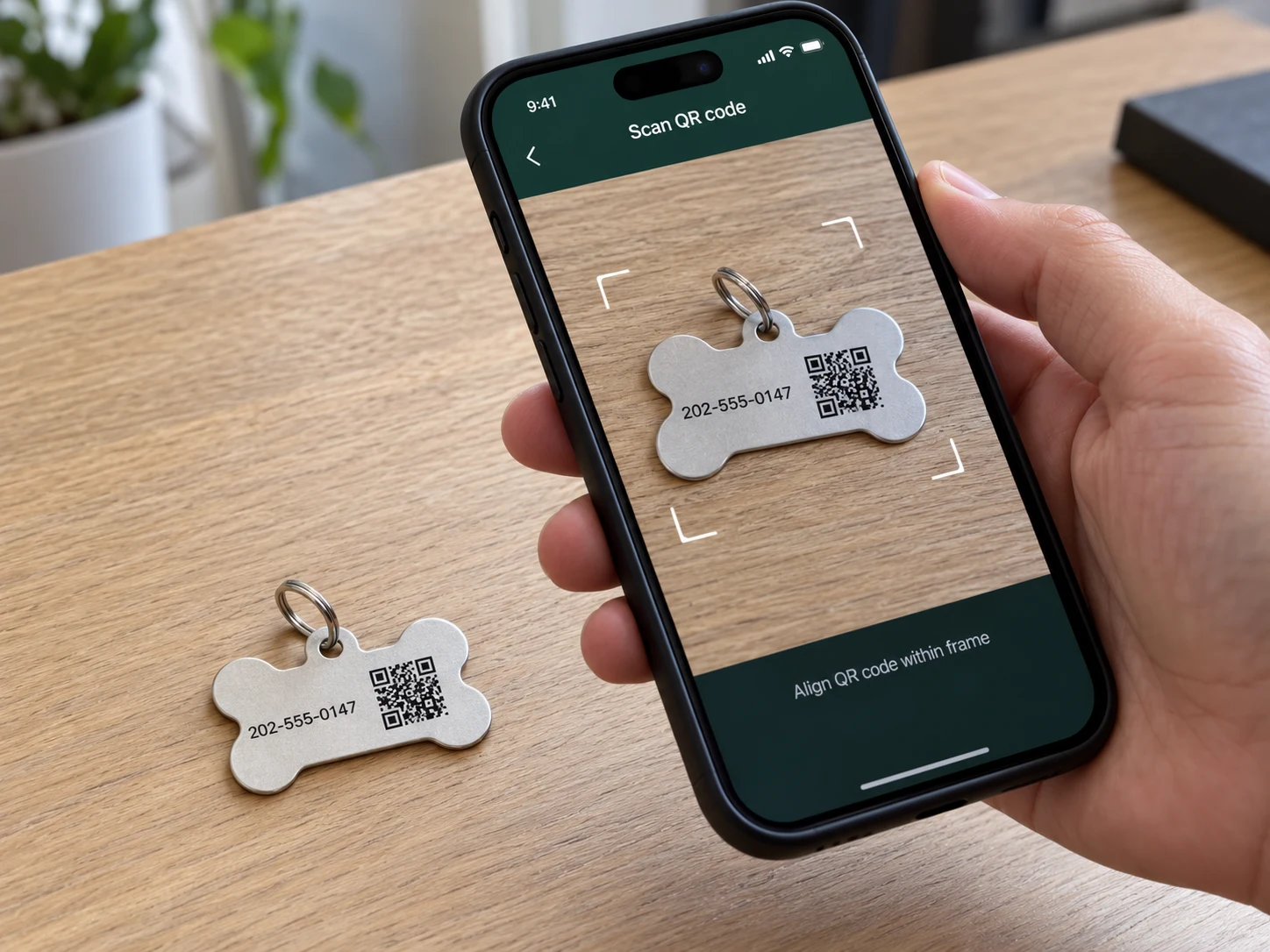 A smartphone camera aimed at the printed QR code on a metal pet tag sample.