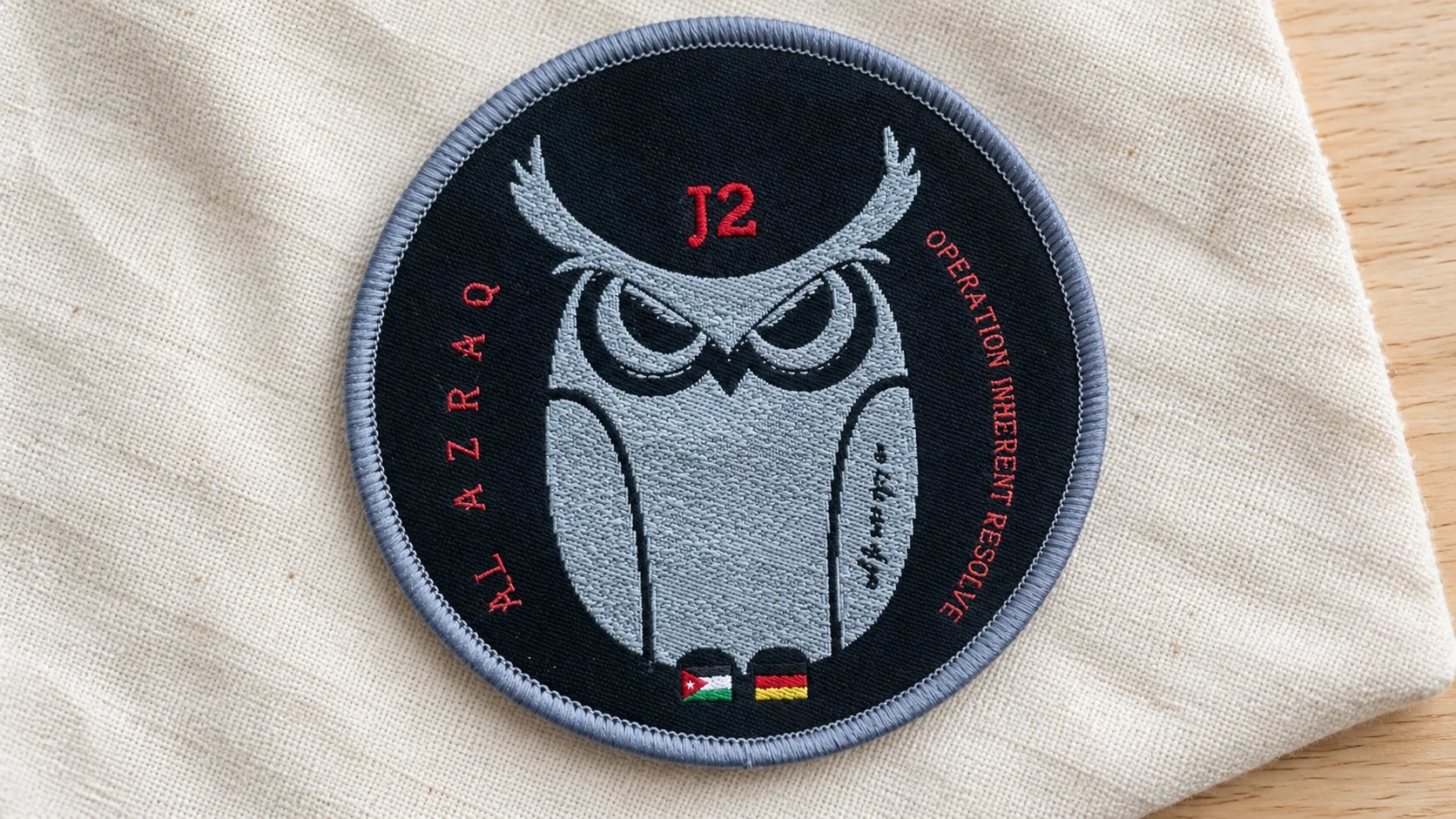 Close-up of small lettering and woven thread detail on a patch.